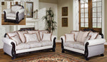 White sofa set with decorative cushions in a living room setting.