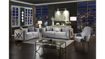 Modern living room with gray sofa, armchair, and coffee table in a stylish interior setting.