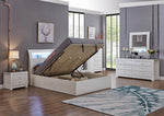 Modern bedroom with a lift-top bed, dresser, and nightstands.