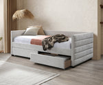 Gray upholstered bed with storage drawers in a room setting.