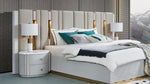 Modern bedroom with a bed, nightstands, and lamps.