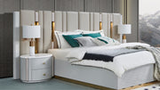 Modern bedroom with a bed, nightstands, and lamps.