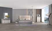 Modern bedroom with gray upholstered bed, nightstands, and dresser.