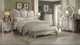Elegant bedroom with ornate furniture and decorative elements.