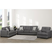 Gray sectional sofa with patterned cushions in a living room setting.