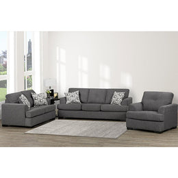 Gray sectional sofa with patterned cushions in a living room setting.