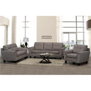 Gray sofa set in a living room with a coffee table and decor items.