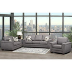 Gray sectional sofa in a living room with large windows showing a cityscape.
