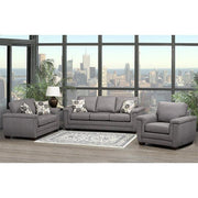 Gray sectional sofa in a living room with large windows showing a cityscape.