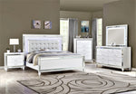 White bedroom furniture set with mirror accents in a room with gray walls and a patterned rug.