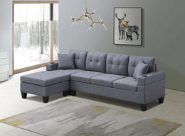 Gray sectional sofa in a living room with a window and wall art.