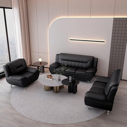 Modern living room with black leather sofa set and round coffee table.