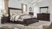 Bedroom set with dark wood furniture including a bed, nightstands, and dresser.