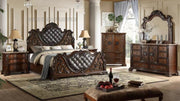 Luxurious bedroom set with dark wood furniture, including bed, dresser, and mirror.