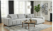 Gray sectional sofa in a living room with a coffee table and decorative items.