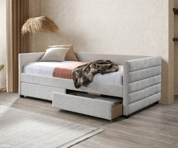 Gray upholstered bed with storage drawers in a room setting.