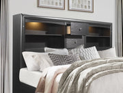 Bedroom with a bed featuring pillows and blankets, and a dark wood headboard with storage.