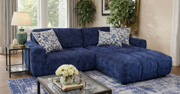 Blue sectional sofa in a living room with decorative pillows and a coffee table.