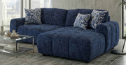 Blue sectional sofa with floral-patterned cushions in a living room setting.
